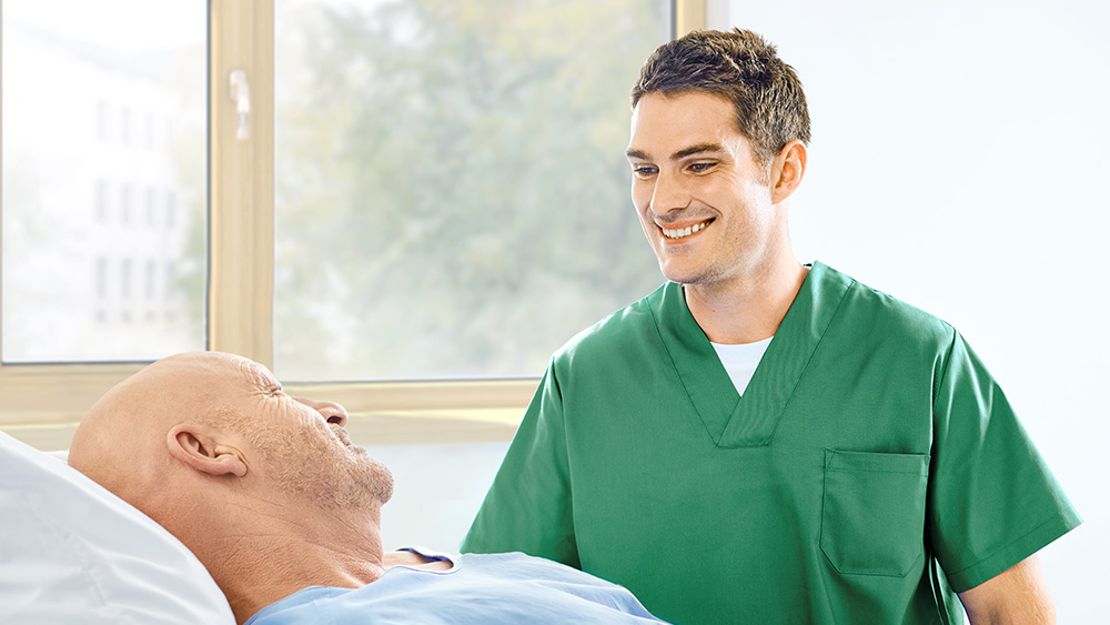 Nurse talking to a patient at the bedside