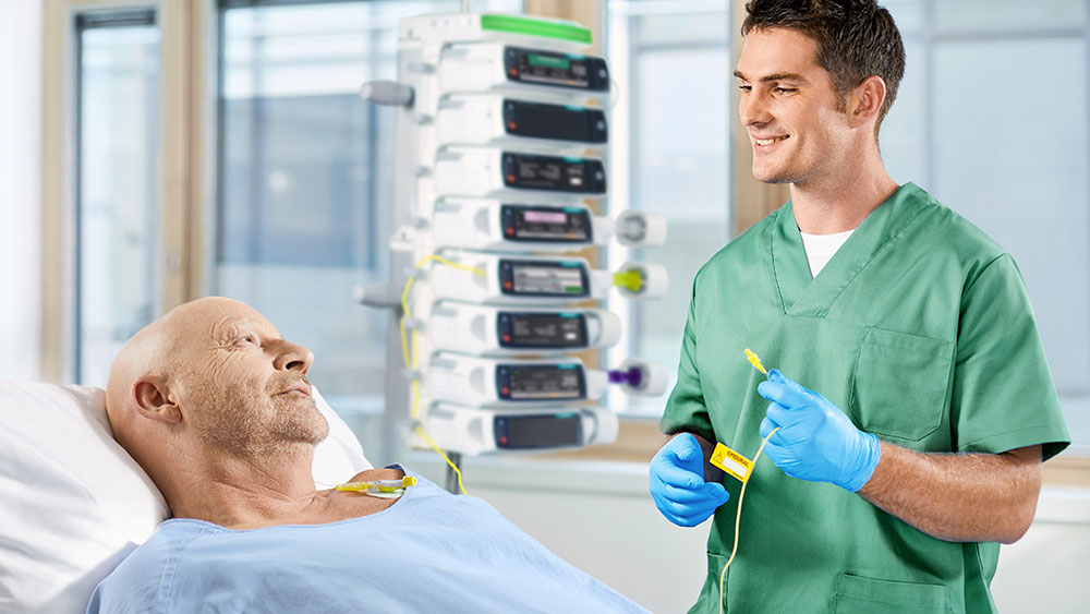 nurse talking with patient at the bedsite