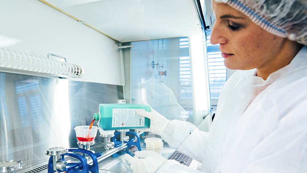 A laboratory worker fills a medical equipment with B. Braun disinfectant. 
